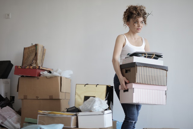 person carrying moving boxes